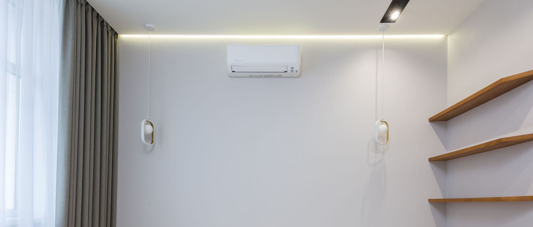 Creative lamps and AC hanging on wall near wooden shelves in modern new apartment with curtains in daylight